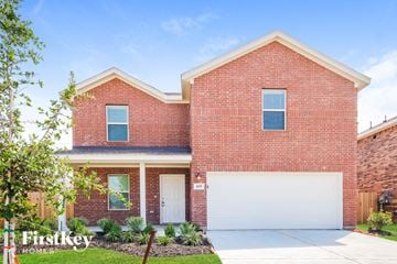 La Marque house for rent - a red brick house with a white garage door