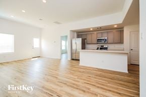 La Marque house for rent - the living room and kitchen of an apartment with wood flooring