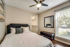 Irving house for rent - a bedroom with a bed and a ceiling fan