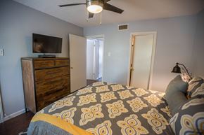 Irving house for rent - another bedroom with a large bed and a tv