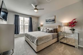 Mckinney house for rent - a bedroom with a bed and a ceiling fan