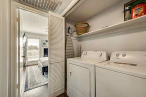 Irving house for rent - a washer and dryer in a laundry room with a door to a bedroom