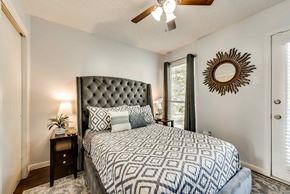 Irving house for rent - a bedroom with a bed and a ceiling fan