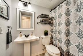 Irving house for rent - a bathroom with a toilet sink and a mirror