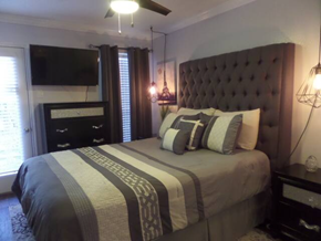 Irving house for rent - a bedroom with a large bed and a tv
