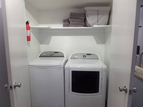 Irving house for rent - a white washer and dryer in a small laundry room