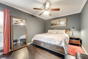 Irving house for rent - a bedroom with a bed and a ceiling fan