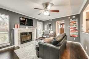 Irving house for rent - a living room with a leather couch and a fireplace