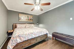 Irving house for rent - a bedroom with a bed and a ceiling fan