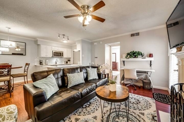 Irving house for rent - a living room with a leather couch and a coffee table