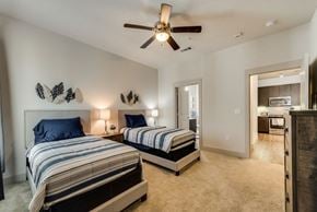Richardson house for rent - a bedroom with two beds and a ceiling fan