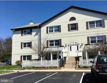 Beltsville apartment for rent - A two-story building with a white picket fence in front.