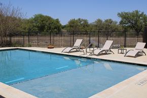 San Antonio house for rent - a swimming pool with two lounge chairs next to it