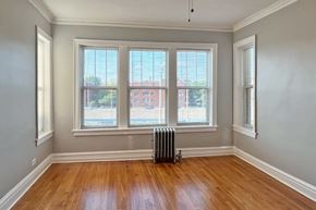 Oak Park apartment for rent - A room with wooden floors and three windows.
