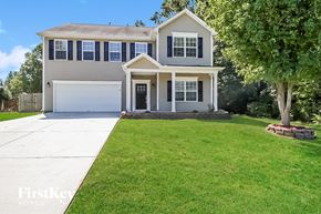 High Point house for rent - a suburban house with a lawn and a white driveway