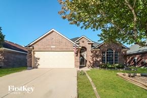 Fort Worth house for rent - a house with a driveway and a garage door