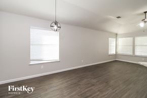 Fort Worth house for rent - a living room with wood floors and white walls and a large window