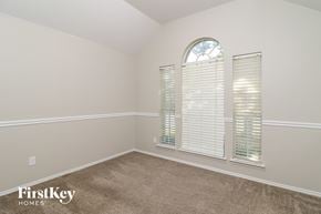 Fort Worth house for rent - the second bedroom has a large window and carpeted flooring