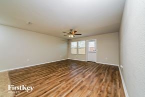 Aubrey house for rent - A room with wooden flooring and a ceiling fan.