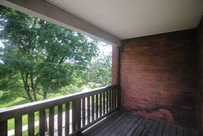 Pittsburgh apartment for rent - a porch with a brick wall and a wooden deck