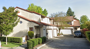 San Leandro apartment for rent - A house with a white garage door and a red tile roof.