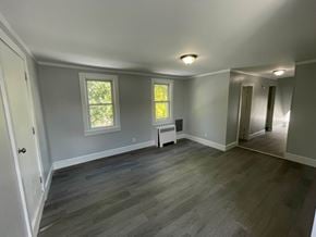 Magnolia apartment for rent - A room with grey flooring and a window.