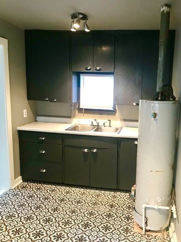 Tulsa house for rent - A kitchen with black cabinets and a white refrigerator.