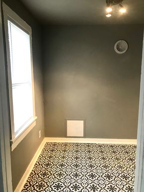 Tulsa house for rent - A room with a patterned floor and a window.