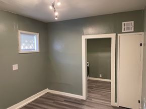 Tulsa house for rent - a room with green walls and a door and a window