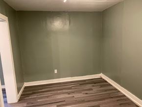Tulsa house for rent - a room with green walls and a wooden floor