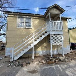 Tulsa house for rent - a yellow house with a white porch and stairs