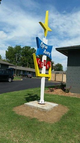 Tulsa apartment for rent - A signpost with a yellow star and a sign that says "Cwrw Abergavenny".