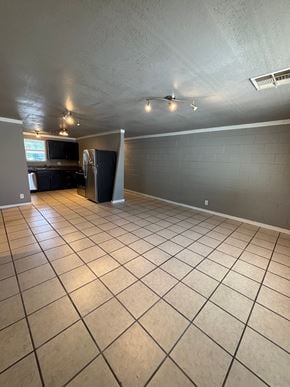Tulsa apartment for rent - A kitchen with a black fridge and a black countertop.