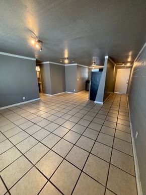 Tulsa apartment for rent - A spacious room with tiled flooring and walls painted in a light grey color.