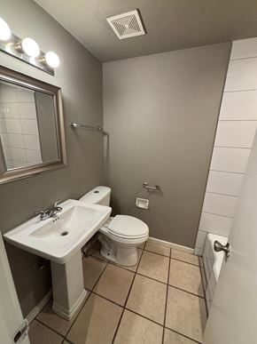 Tulsa apartment for rent - A bathroom with a toilet, sink, and mirror.