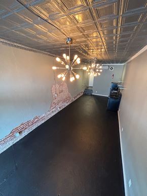 Tulsa apartment for rent - A long hallway with lights on the ceiling.