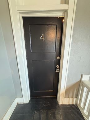 Tulsa apartment for rent - A black door with the number 4 on it.