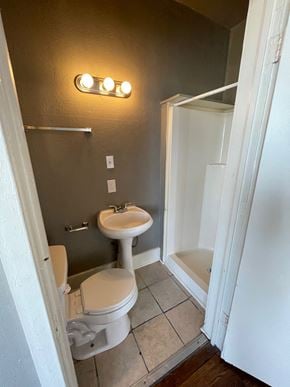 Tulsa apartment for rent - A bathroom with a toilet, sink, and shower.