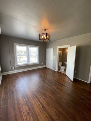 Tulsa apartment for rent - A room with wooden floors and a window.