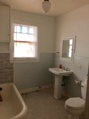 Tulsa apartment for rent - A bathroom with a toilet, sink, and tub.