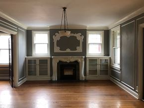 Tulsa apartment for rent - A large room with a fireplace and a chandelier.
