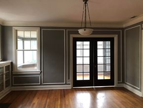 Tulsa apartment for rent - A room with a wooden floor and a chandelier hanging from the ceiling.