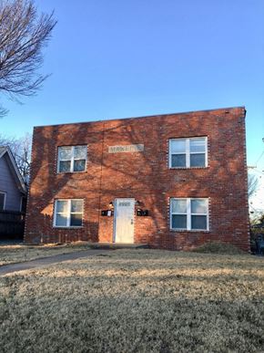 Tulsa apartment for rent - an old brick building with a white door