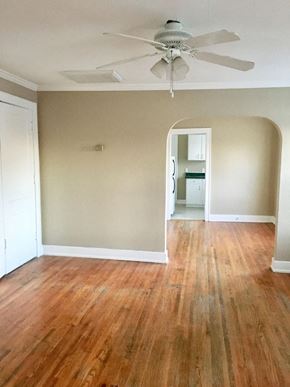 Tulsa apartment for rent - an empty living room with wood floors and a ceiling fan