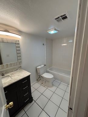 Tulsa apartment for rent - A bathroom with a toilet, sink, and mirror.