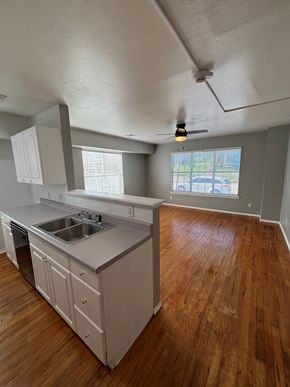 Tulsa apartment for rent - A kitchen with wooden floors and a window.