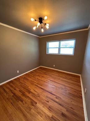 Tulsa apartment for rent - A room with wooden flooring and a ceiling fan with lights.