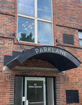 Tulsa apartment for rent - A brick building with a black awning that says "PARKLANE".