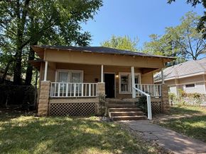 Tulsa house for rent - A small house with a porch and a front yard.