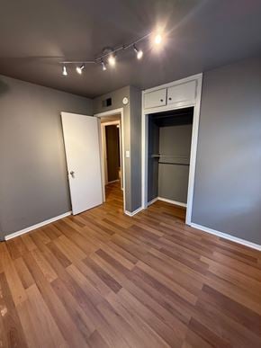 Tulsa house for rent - A room with a wooden floor and a white door.